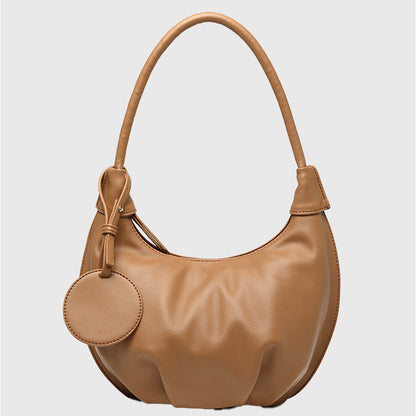 Woman styling fresh soft leather crescent dumpling bag