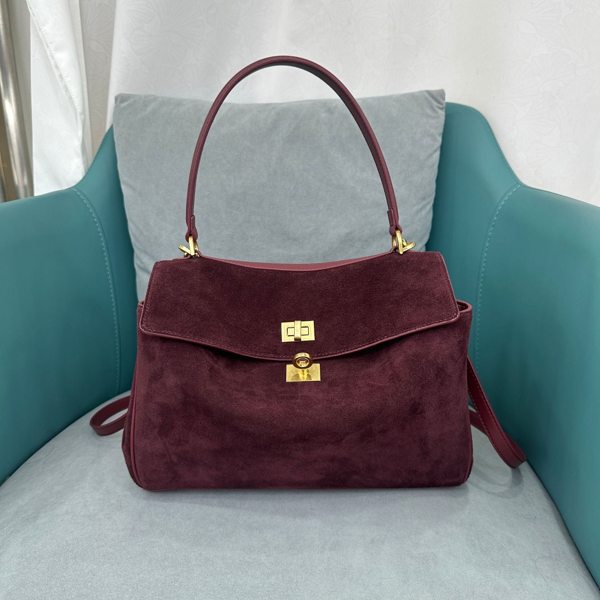 Close-up of matte leather and gold-tone buckle detailing