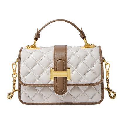 Milky white cowhide crossbody bag styled with neutral outfit