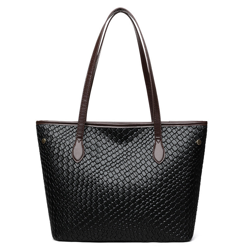 Woman carrying retro commuter PU leather handbag on shoulder