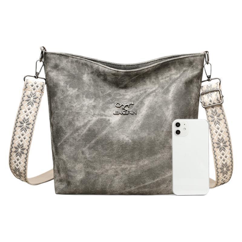 Woman wearing large PU leather crossbody bag in casual outfit