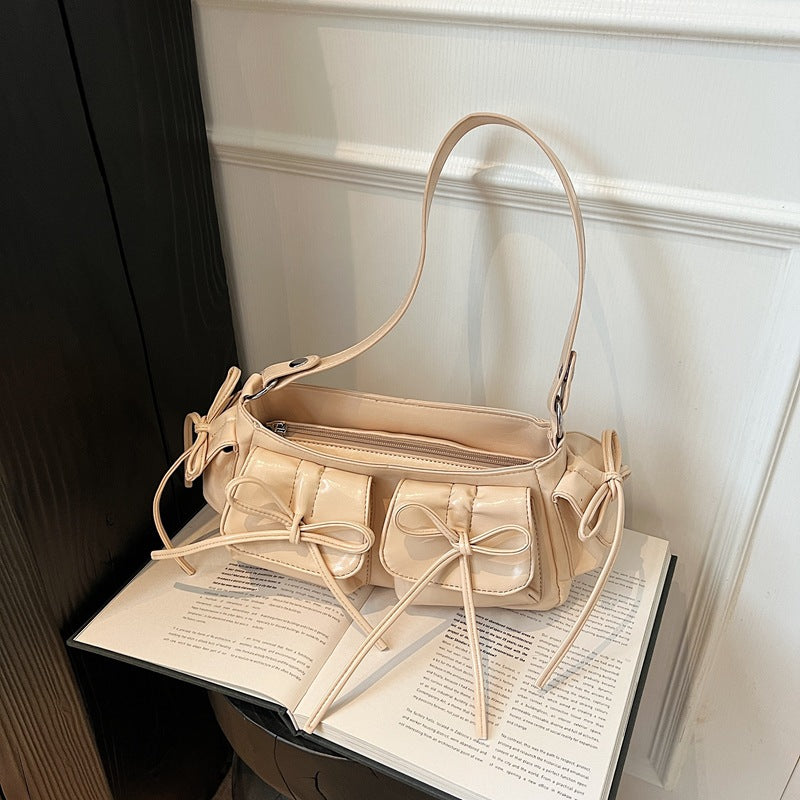 Pink pleated PU leather handbag with tassel and bow