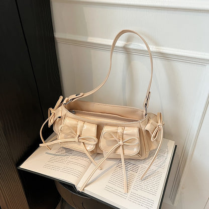 Pink pleated PU leather handbag with tassel and bow