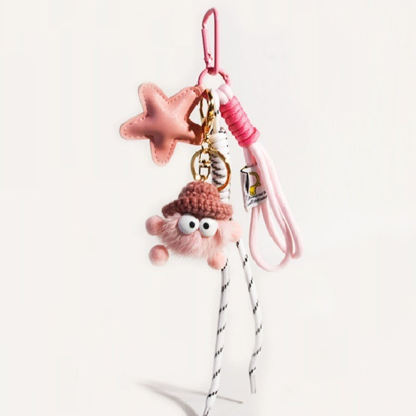 pink metal bag charm with star design