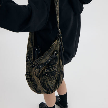 Model wearing denim punk bag with strap