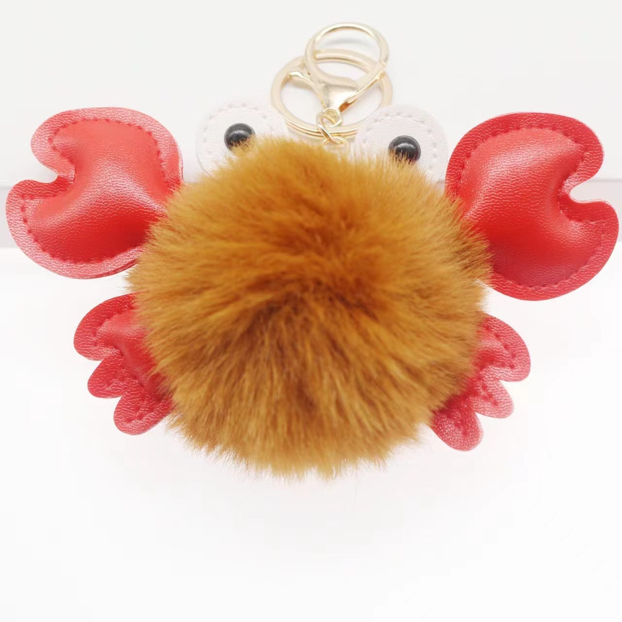 rab-shaped keychain with a brown fuzzy ball