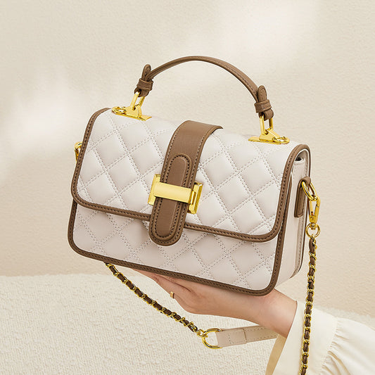 Black rhombus-textured cowhide bag shown from an angle