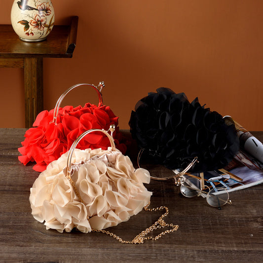 Three floral handbags in red, beige, and black on a wooden table with a brown background.