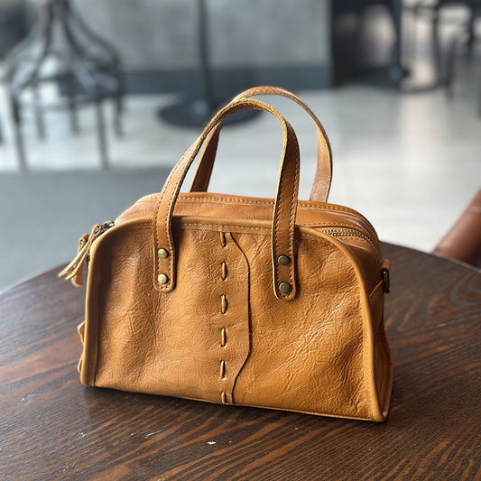 Brown women's minimalist cowhide crossbody with visible stitching
