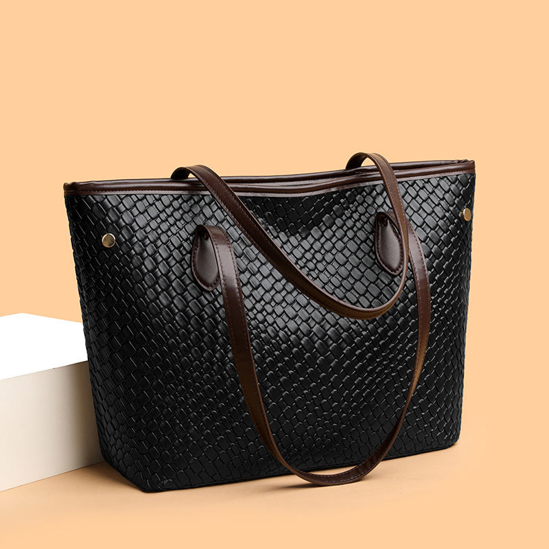 Side view of large capacity commuter handbag in PU leather