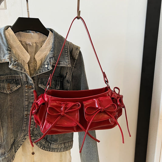 Front view of women’s pleated PU leather handbag with tassel bow