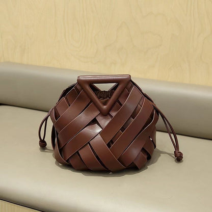 Leather bucket bag with triangle top shown on display stand