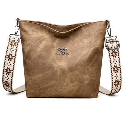 Close-up of shoulder strap on PU leather crossbody tote bag